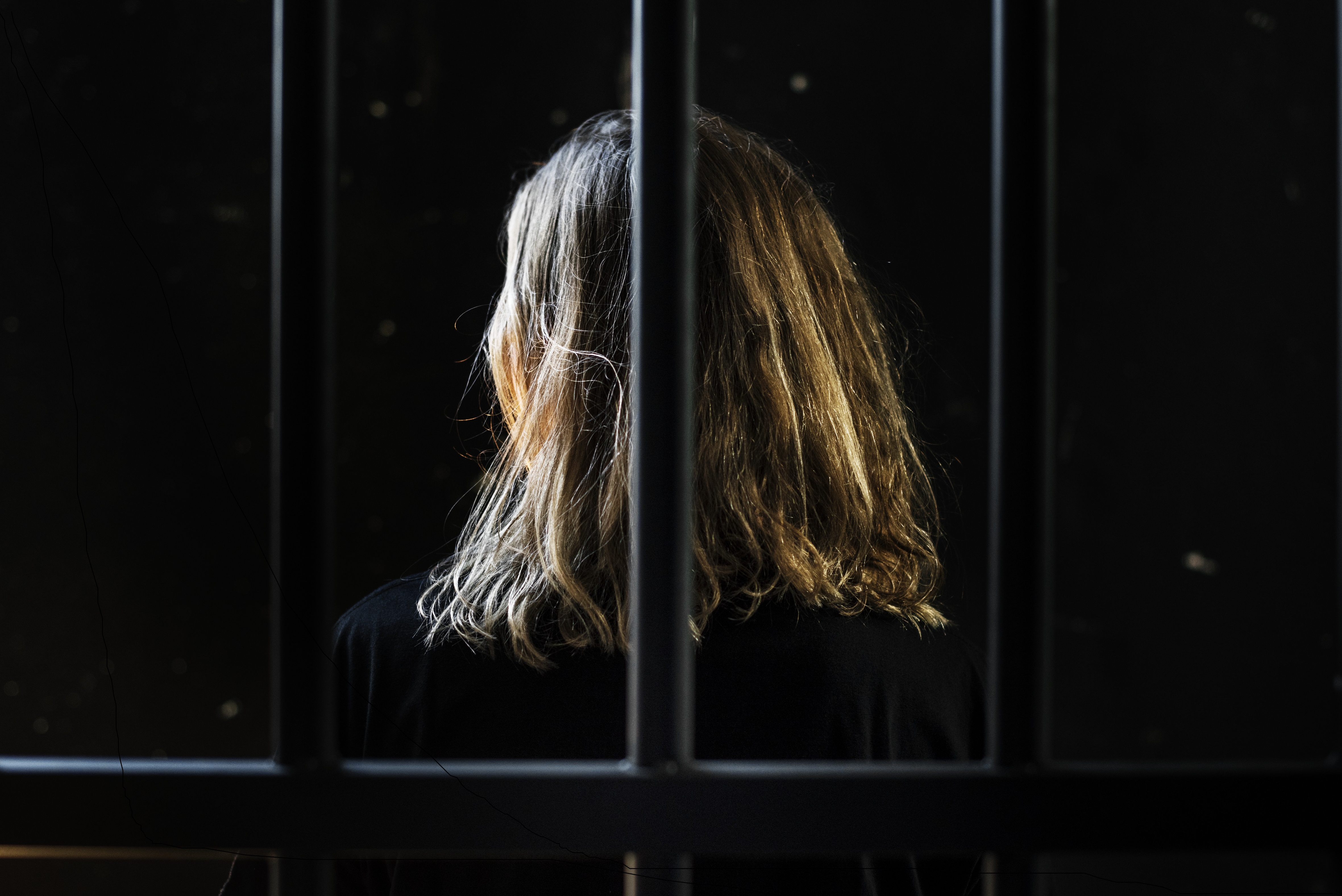 Image of woman behind bars